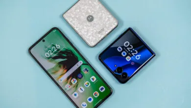 Three Motorola Razr phones displayed on a light blue surface, showcasing different designs.