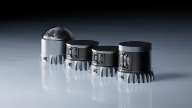 Four cylindrical sensors with unique designs, arranged on a reflective surface.