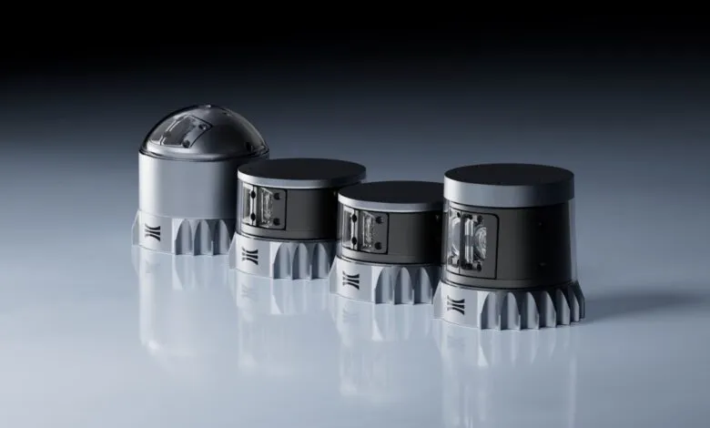 Four cylindrical sensors with unique designs, arranged on a reflective surface.