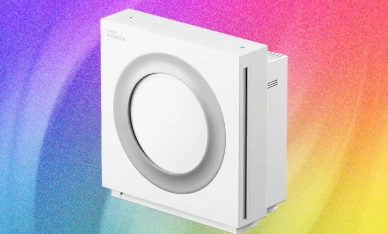 Coway Airmega Mighty air purifier, white, against a colorful background.