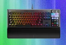 Corsair gaming keyboard with RGB lighting and integrated LCD screen.