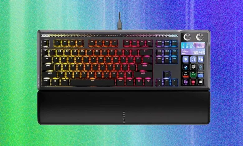 Corsair gaming keyboard with RGB lighting and integrated LCD screen.