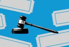 Gavel on block surrounded by tickets against a blue background.