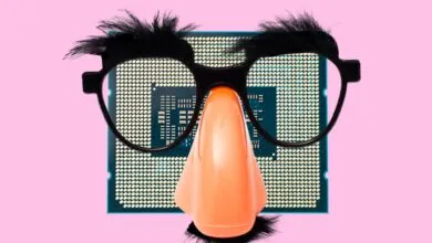 CPU chip wearing Groucho Marx glasses and nose on pink background.