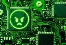 Green circuit board with an angry pixelated face on a chip.