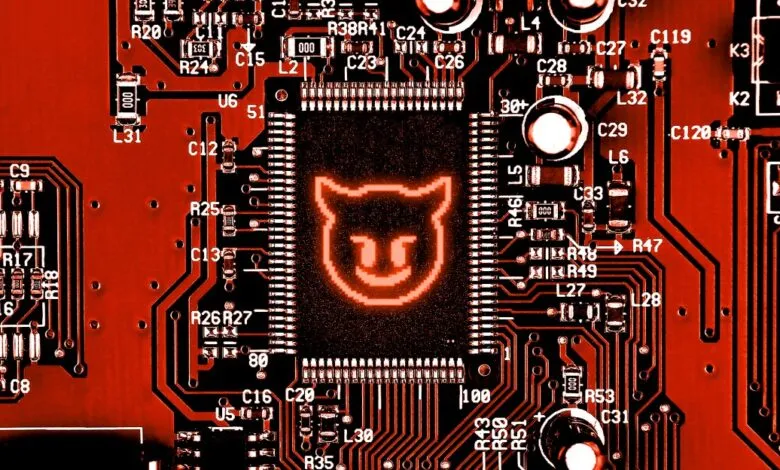 Close-up of a red circuit board with a glowing devil icon on the central chip.