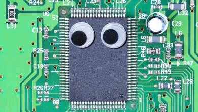 Circuit board with googly eyes on chip, creating a funny face.