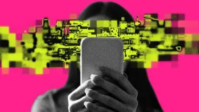 Person holding phone with pixelated face on pink background.