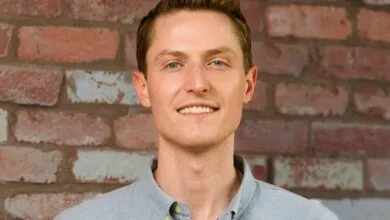Sean Henry, CEO of Stord, poses against a brick wall.