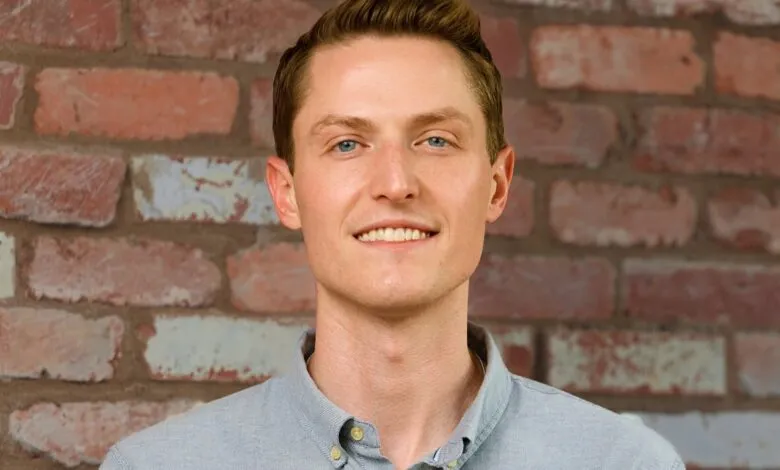 Sean Henry, CEO of Stord, poses against a brick wall.