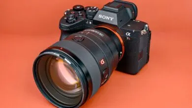 Sony Alpha 7R V camera with lens on orange background.