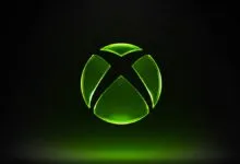 Glowing green Xbox logo on a black background.