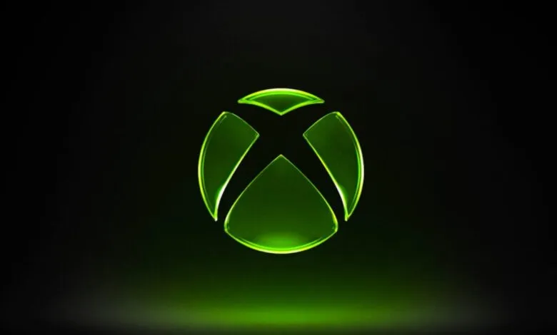 Glowing green Xbox logo on a black background.