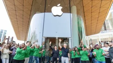Tim Cook and Deirdre O'Brien wave at Apple BKC store opening in Mumbai.