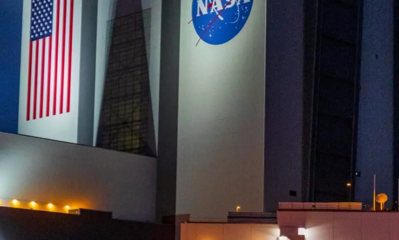 Exterior view of NASA building with American flag and NASA logo.