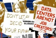 Protesters holding signs about AI, data centers, and workers' rights.