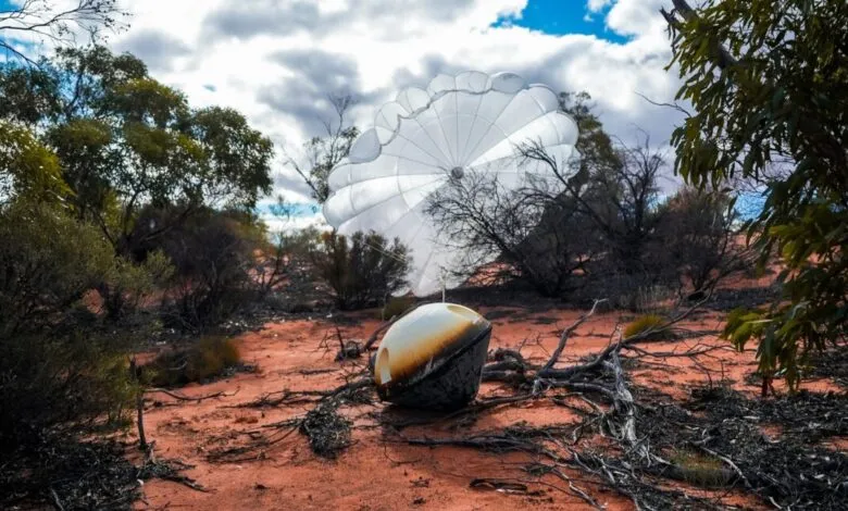 Varda W-3 capsule with parachute landed in a desert landscape.
