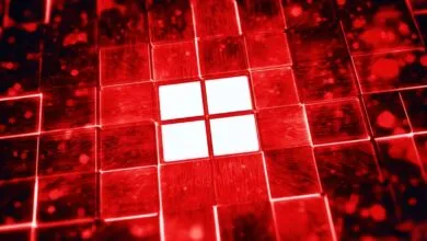 Red Windows logo made of glowing squares with circuit board patterns.