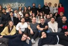 Group photo of Wirestock team members smiling and posing together indoors.