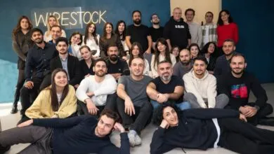 Group photo of Wirestock team members smiling and posing together indoors.