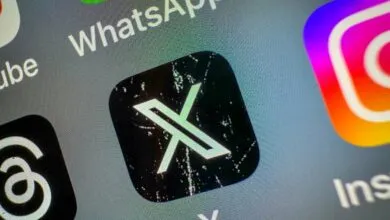 Close-up of a smartphone screen showing the X app icon among other app icons.