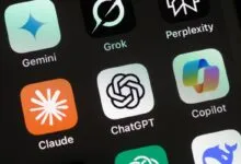 Close-up of AI app icons on a smartphone screen: Gemini, Grok, ChatGPT, Copilot.