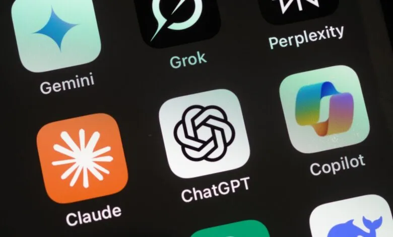 Close-up of AI app icons on a smartphone screen: Gemini, Grok, ChatGPT, Copilot, Claude, Perplexity.