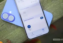 Two smartphones showing file sharing interface on a wooden surface.