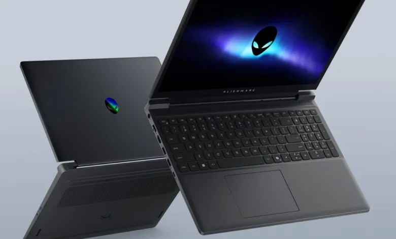 Two Alienware laptops, one open with logo on screen, one closed.