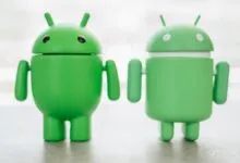 Two green Android robot figurines stand side-by-side.