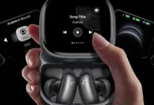 Hand holding Anker Liberty 4 NC earbuds case with touch screen interface.