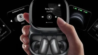 Hand holding Anker Liberty 4 NC earbuds case with touch screen interface.