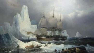 Tall ship navigating icy Arctic waters with crew in small boats.