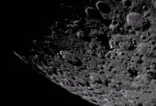 Detailed view of the moon's cratered surface, with deep shadows and varying textures.