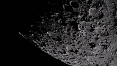 Detailed view of the moon's cratered surface, with deep shadows and varying textures.