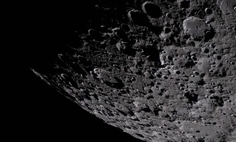 Detailed view of the moon's cratered surface, with deep shadows and varying textures.
