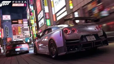 Nissan GT-R racing through a vibrant, neon-lit Tokyo street at night.