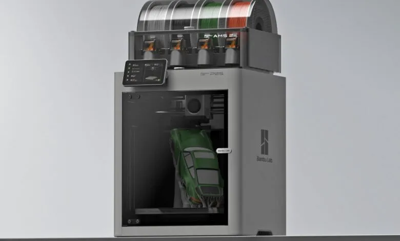 Bambu Lab P1S 3D printer printing a green car with AMS filament system.