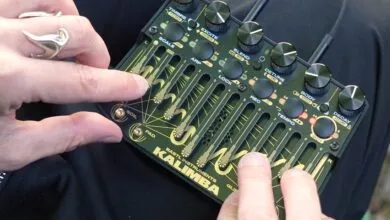 Hands play Bastl Instruments Kalimba, a unique electronic musical instrument.