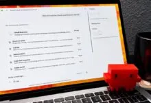 Laptop displaying Claude AI business skills with a red toy figure.