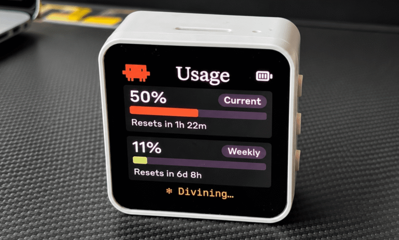 Cube-shaped device displaying usage statistics on a black screen.