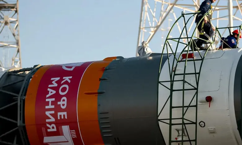 Rocket with 'Kofe Mania' branding being prepped for launch.