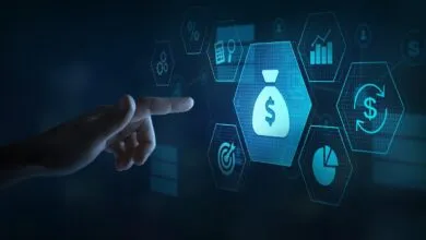 Hand interacts with digital money and finance icons on a screen.