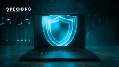 Laptop displays a glowing blue shield, symbolizing cybersecurity protection.
