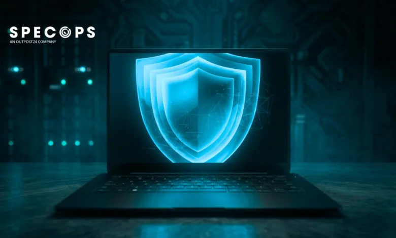 Laptop displays a glowing blue shield, symbolizing cybersecurity protection.