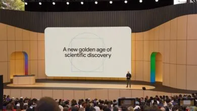 Demis Hassabis presents 'A new golden age of scientific discovery' on stage.