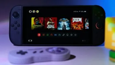 Handheld gaming console displaying game selection screen with controller.