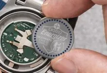 Energizer CR2032 battery being installed in a watch.