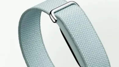 Close-up of a light blue woven Fitbit band with a silver buckle.