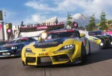 Racing cars drift at Horizon Festival, mountain backdrop, cheering crowd.